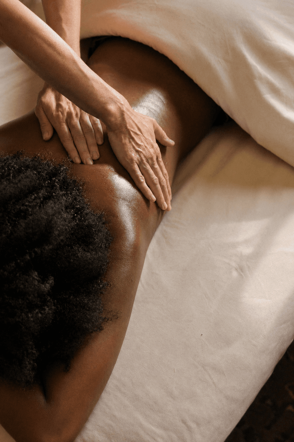 des mains qui massent un dos avec de l'huile, détente